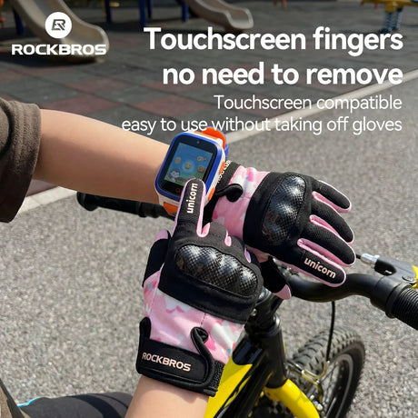Person wearing pink gloves with touchscreen compatibility on a bicycle, featuring RockBros branding.